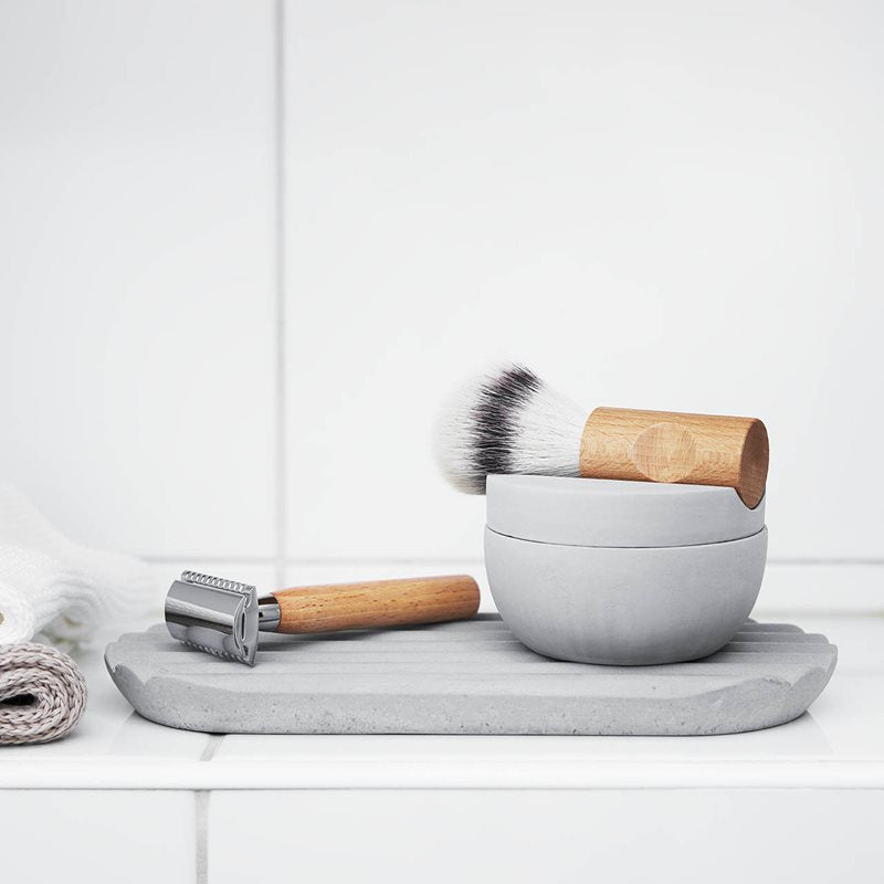A shaving brush and bowl on an Iris Hantverk Concrete Tray.