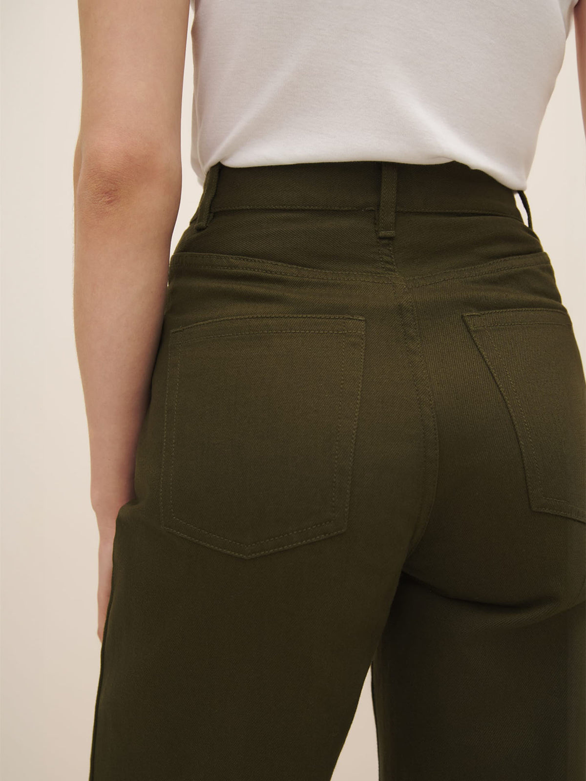 The back view of a woman in Kowtow fairtrade organic cotton Straight Leg Jeans – Khaki Denim.