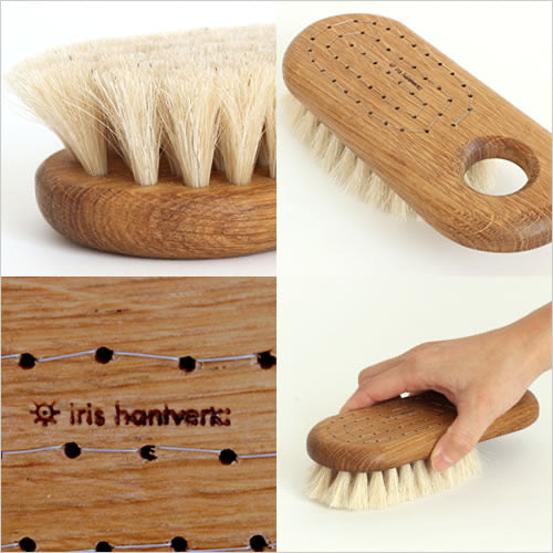 A Body Brush – Firm by Iris Hantverk, with a hand holding it.