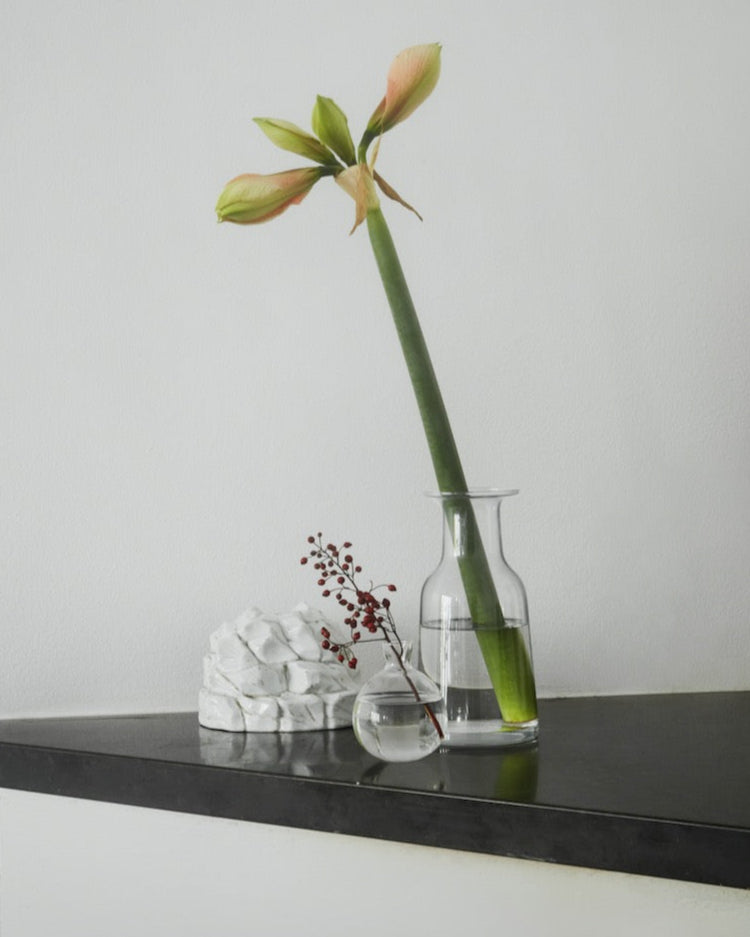 A Hammer Decanter by Skagerak sits on top of a counter.