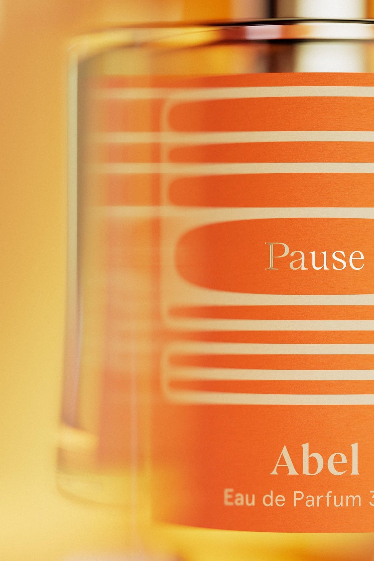 A bottle of Abel perfume with a Pause violet leaf background.