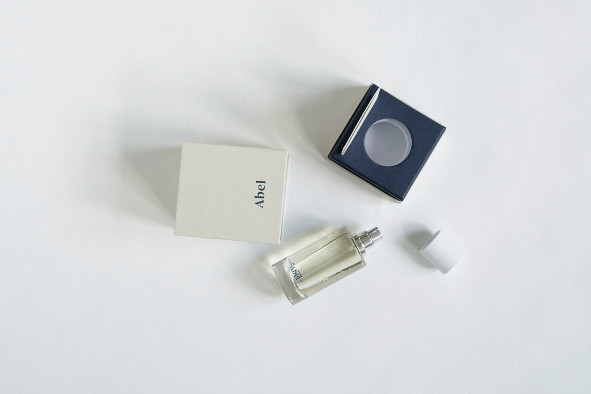 A bottle of Cobalt Amber eau de parfum from Abel on a white surface.