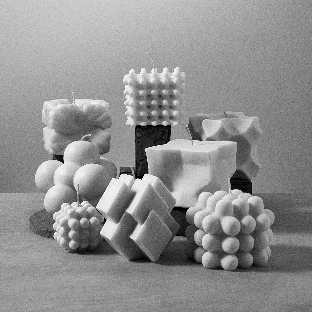 A black and white photo of a group of Andrej Urem Crux Candles.