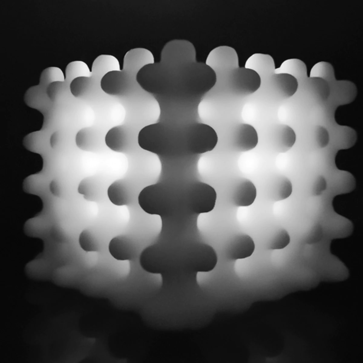 A black and white photo of an Andrej Urem Lace Candle light sculpture.