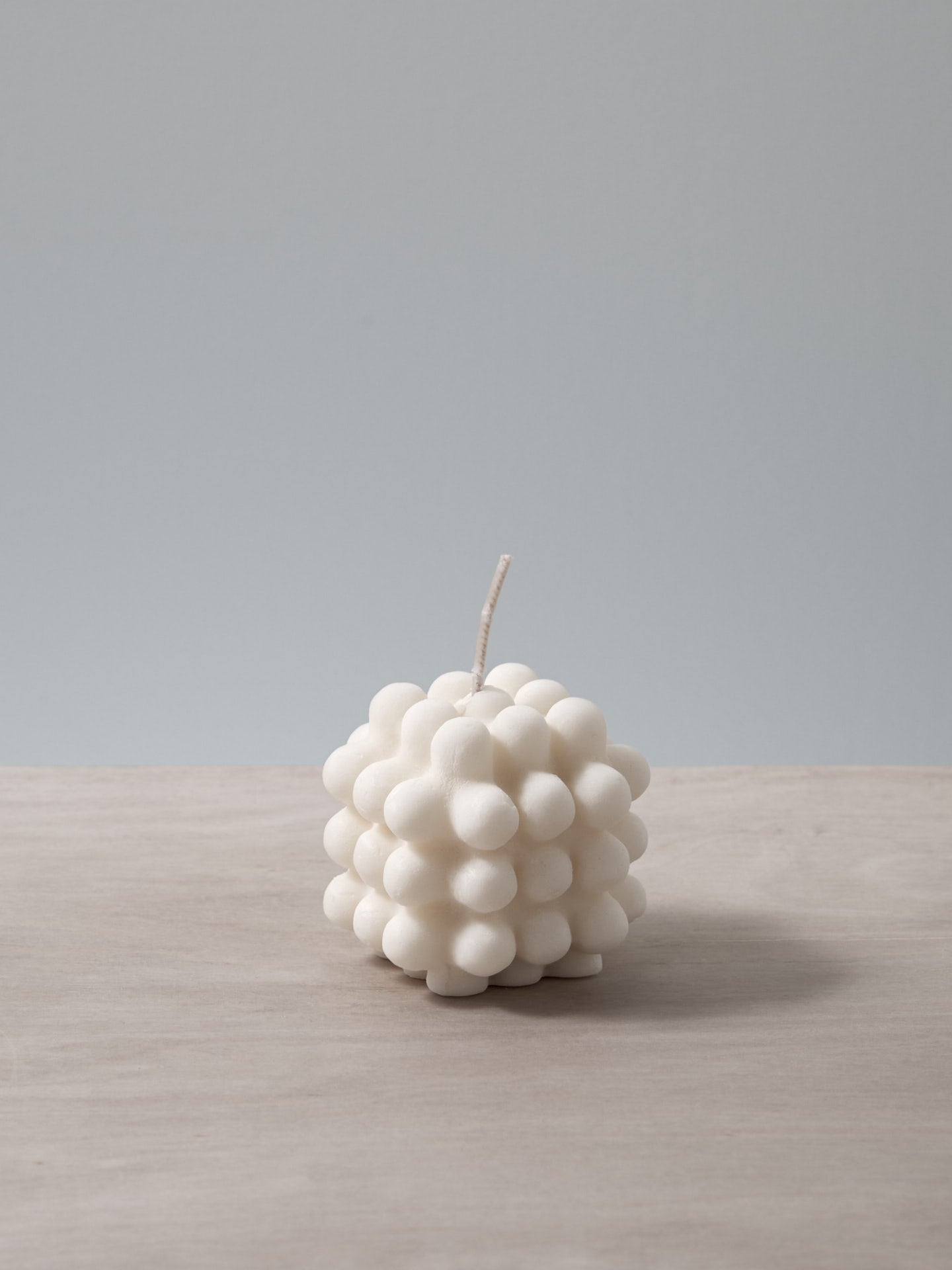 A Milk Candle - mini by Andrej Urem sitting on top of a table.