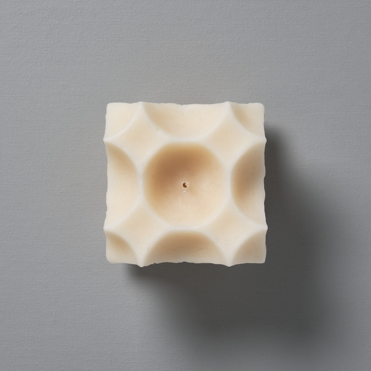 A Crux Candle by Andrej Urem, on a gray background.