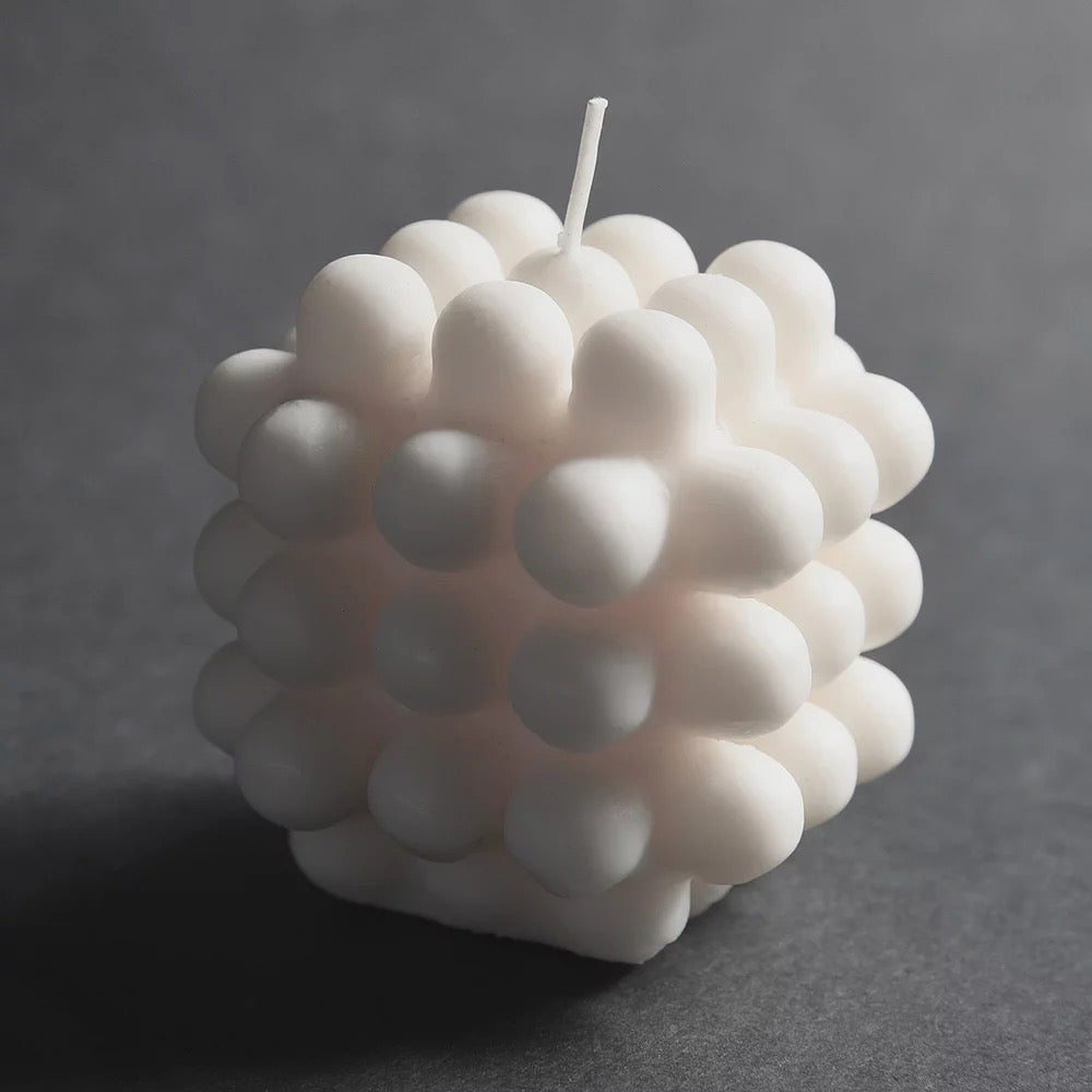 A Milk Candle - mini with white balls on it, made by Andrej Urem.