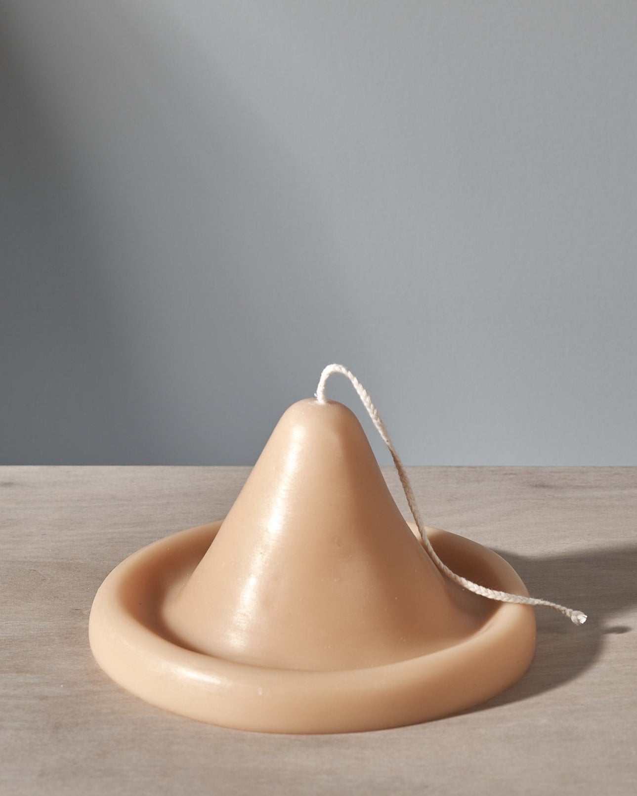 An Onno Candle shaped like a hat sitting on a table.