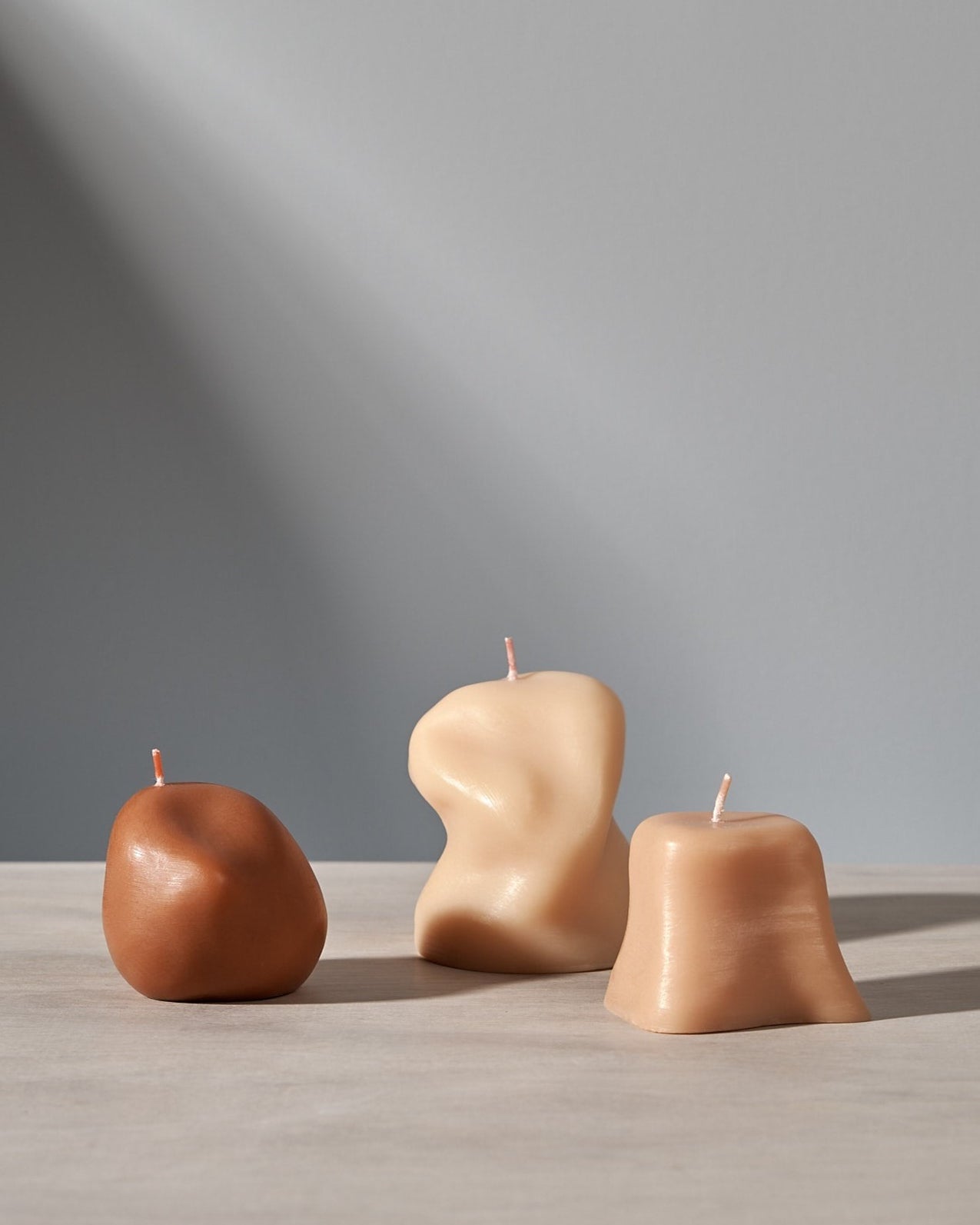 Three Sole Set candles sitting on a table next to each other. (Brand: ann vincent)