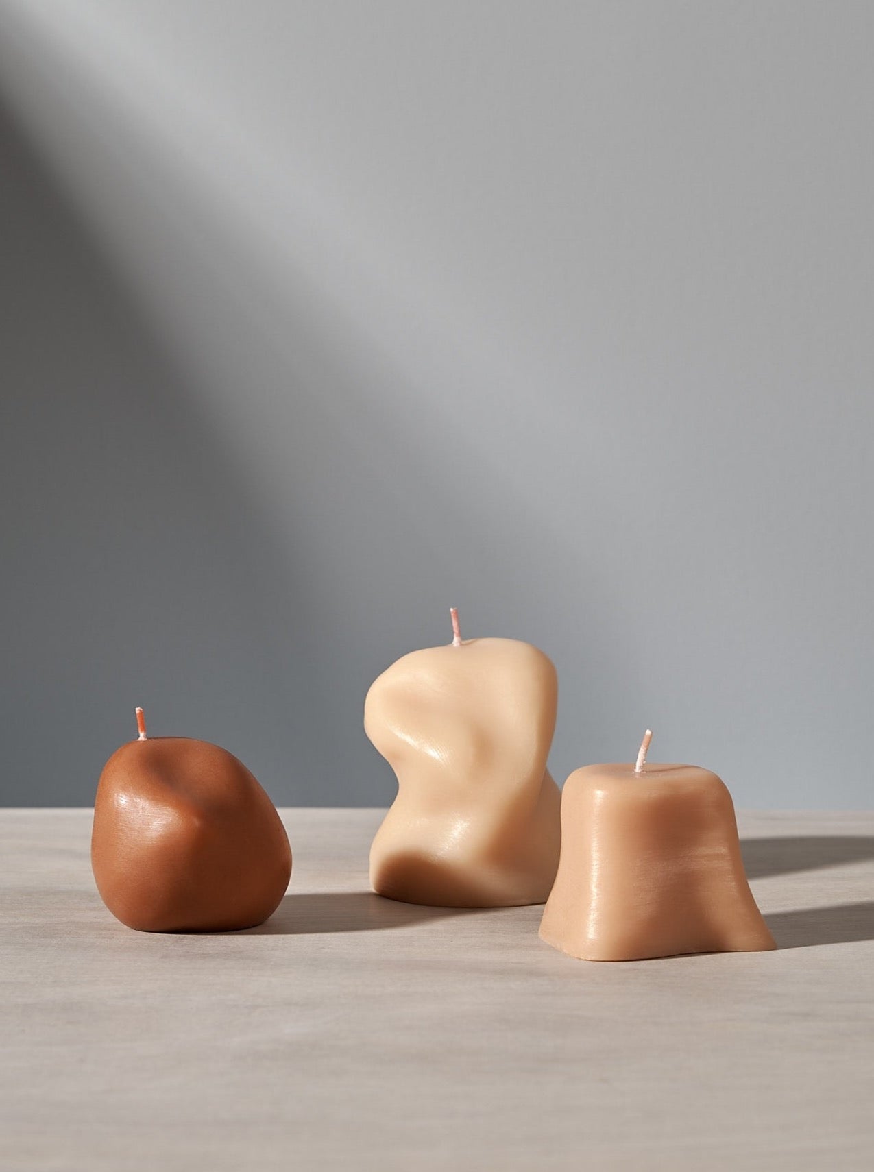 Three Sole Set candles sitting on a table next to each other. (Brand: ann vincent)