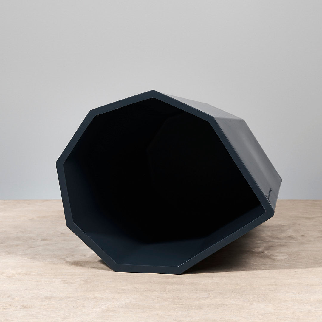 An Arnold Circus Stool - Navy by Martino Gamper sitting on top of a table.