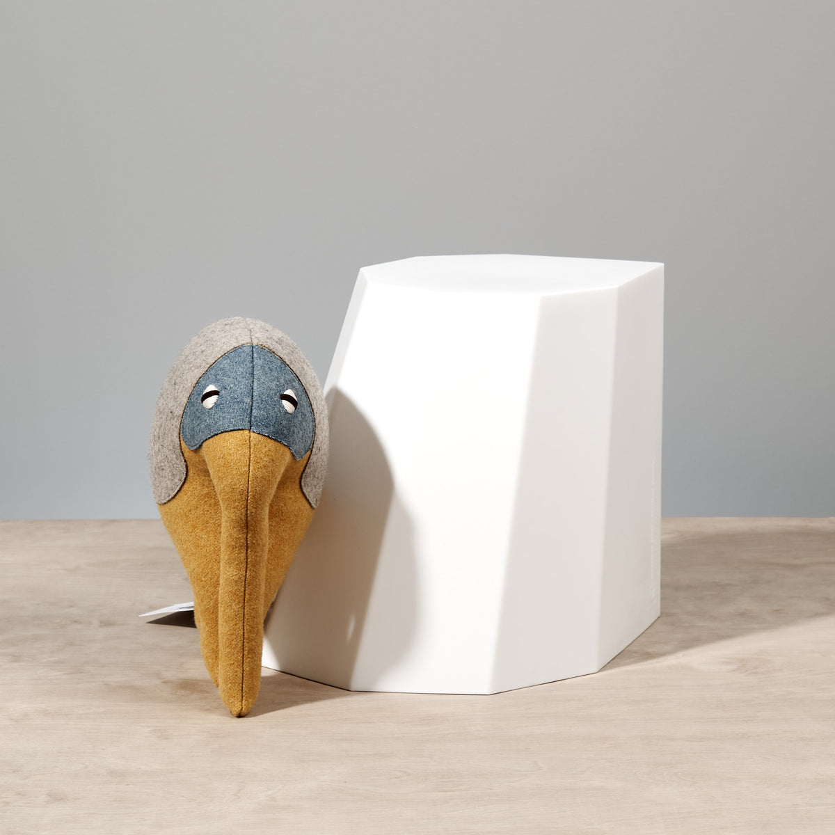 An Arnoldino Stool – Chalk sits on top of a white cube. (Brand: Martino Gamper)