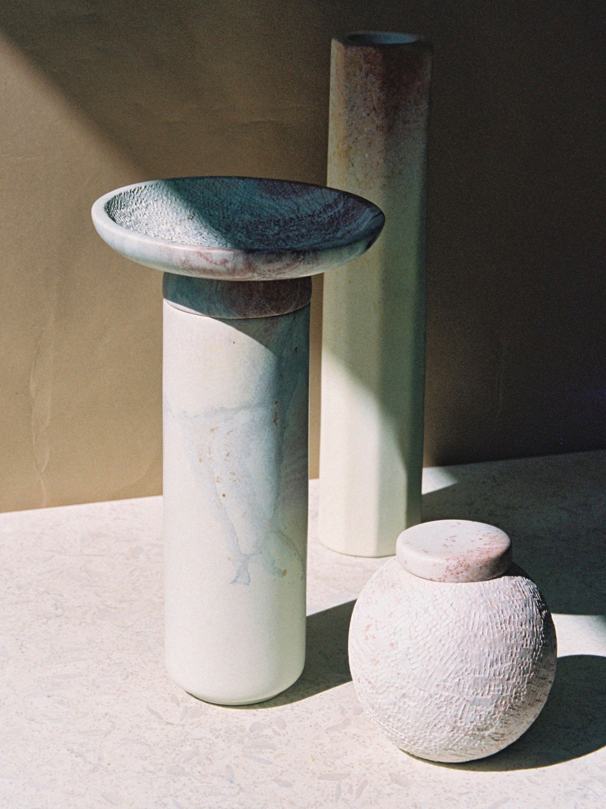 Three Amina Bowl Set Tall – Pink vases on a table.