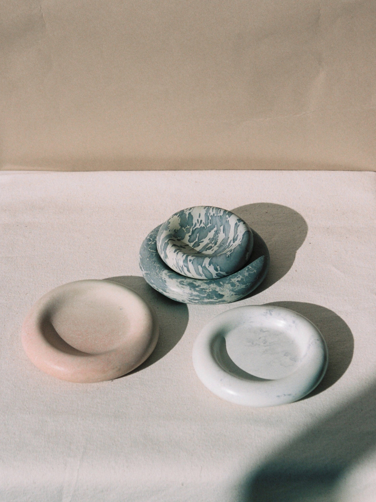 Three Stacker Round Trays – Malachite by Asili on a white table.