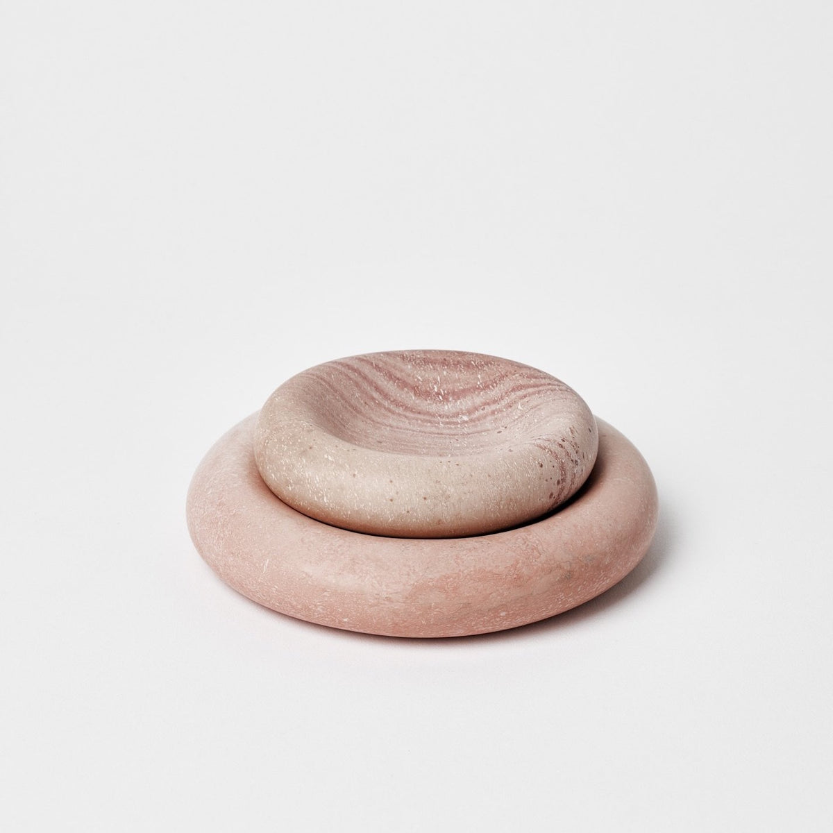A pair of Asili Stacker Round Tray – Pink bowls stacked on top of each other.