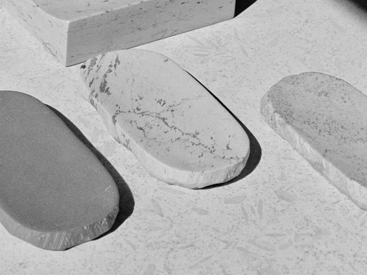 A black and white photo of three Asili Malachite Textured Trays on a table.