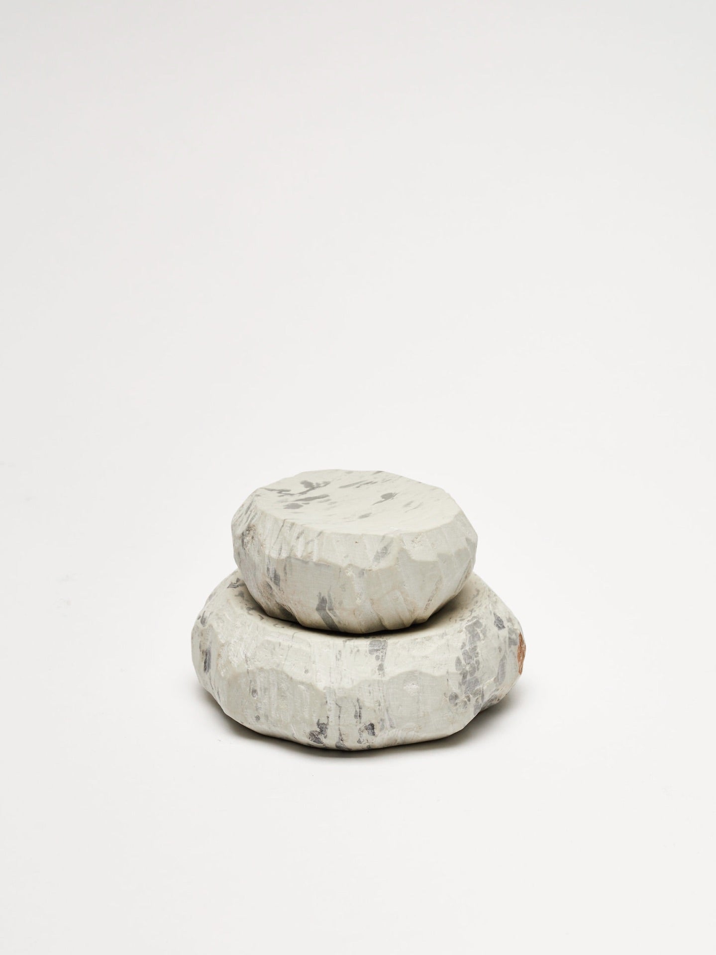 A stack of Textured Dish Sets - Malachite by Asili on a white surface.