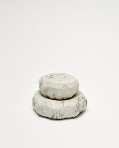 A stack of Textured Dish Sets - Malachite by Asili on a white surface.