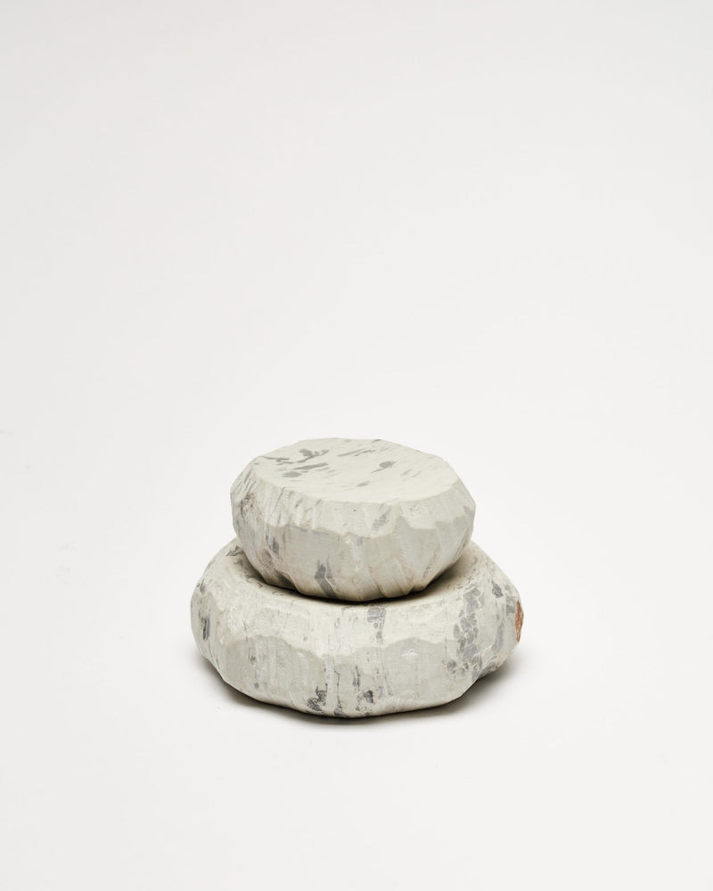 A stack of Textured Dish Sets - Malachite by Asili on a white surface.