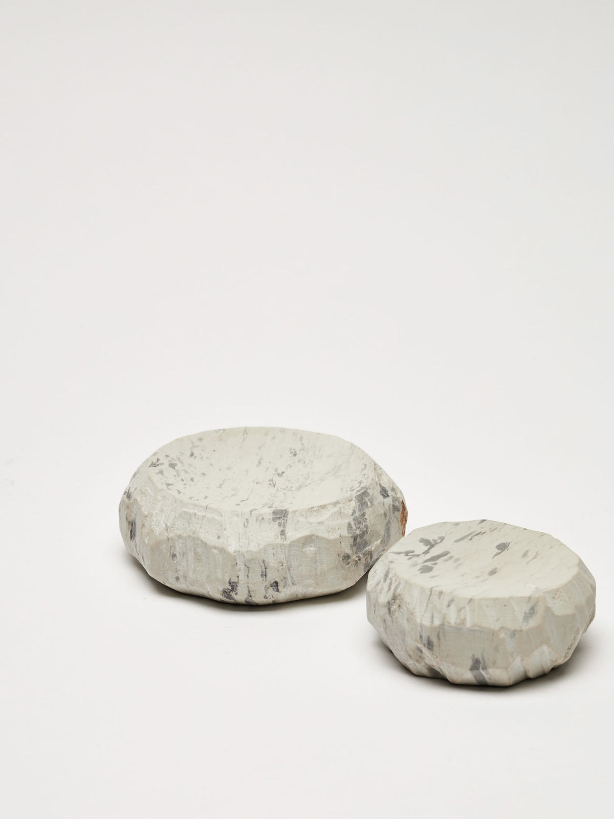 A pair of white and gray Textured Dish Set – Malachite ceramic spheres on a white surface. Brand Name: Asili