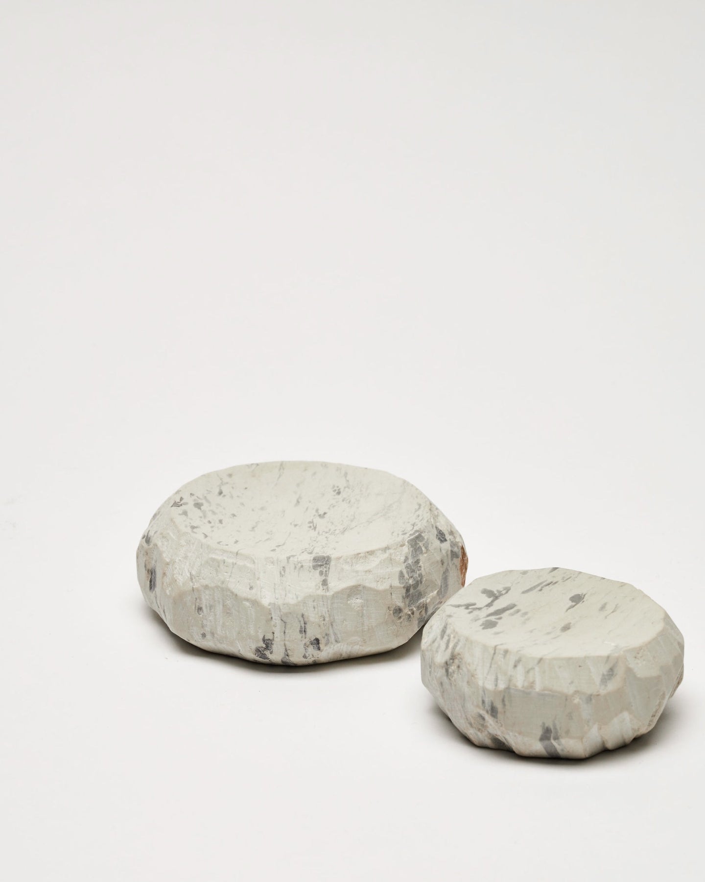 A stack of Textured Dish Sets - Malachite by Asili on a white surface.