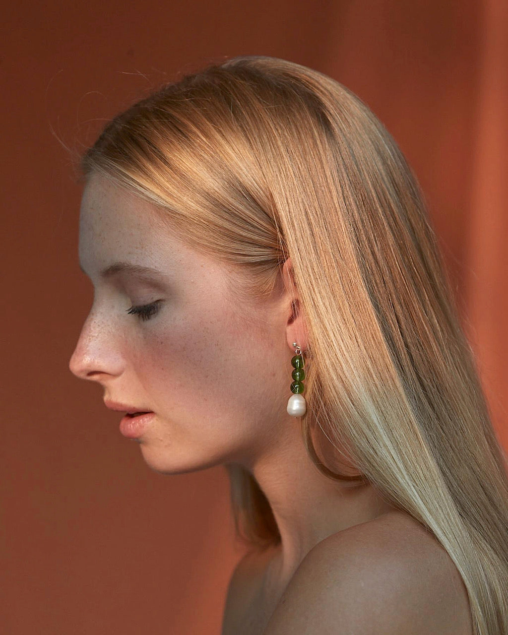 A woman wearing a pair of Jealousy Drops earrings from Avara Studio.