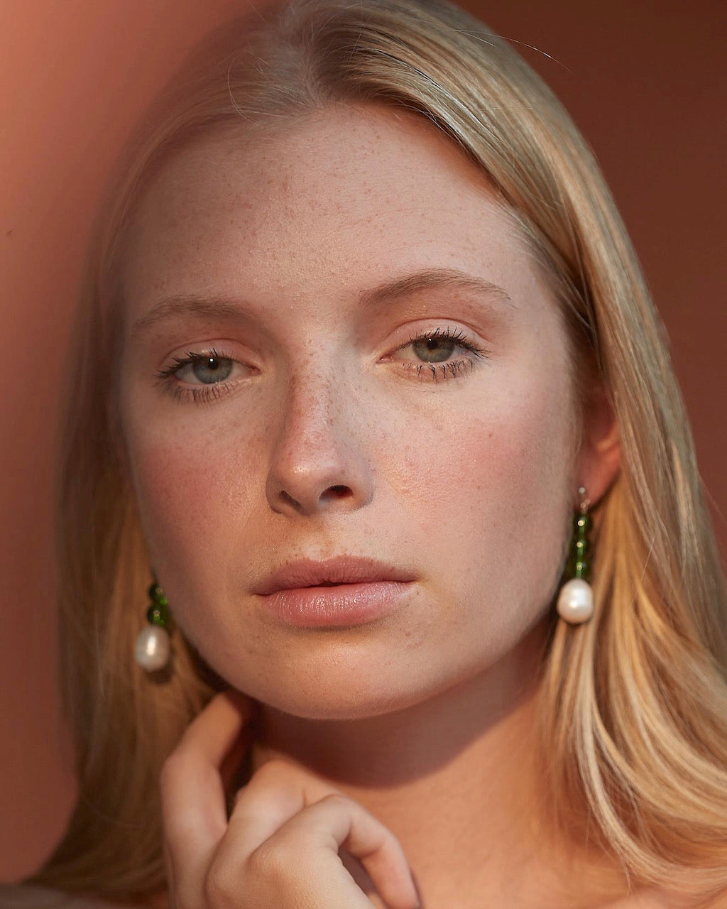 A woman with blonde hair and pearl earrings is posing for a photo wearing Avara Studio's Jealousy Drops.