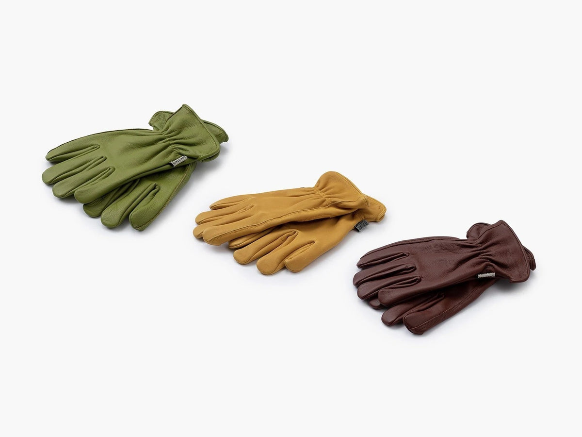 Three different colored Classic Work Gloves – Natural Yellow by Barebones on a white surface.