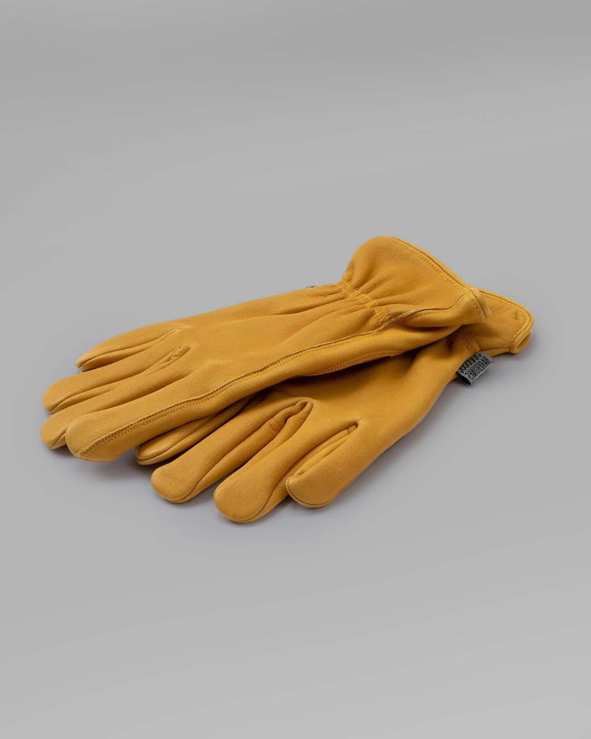 A pair of Classic Work Gloves - Natural Yellow by Barebones on a white background.