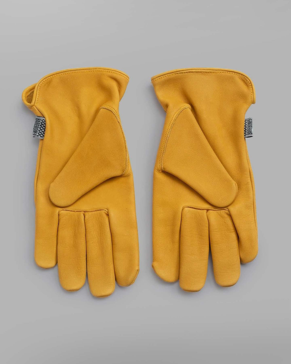 A pair of Barebones Classic Work Gloves – Natural Yellow on a white background.