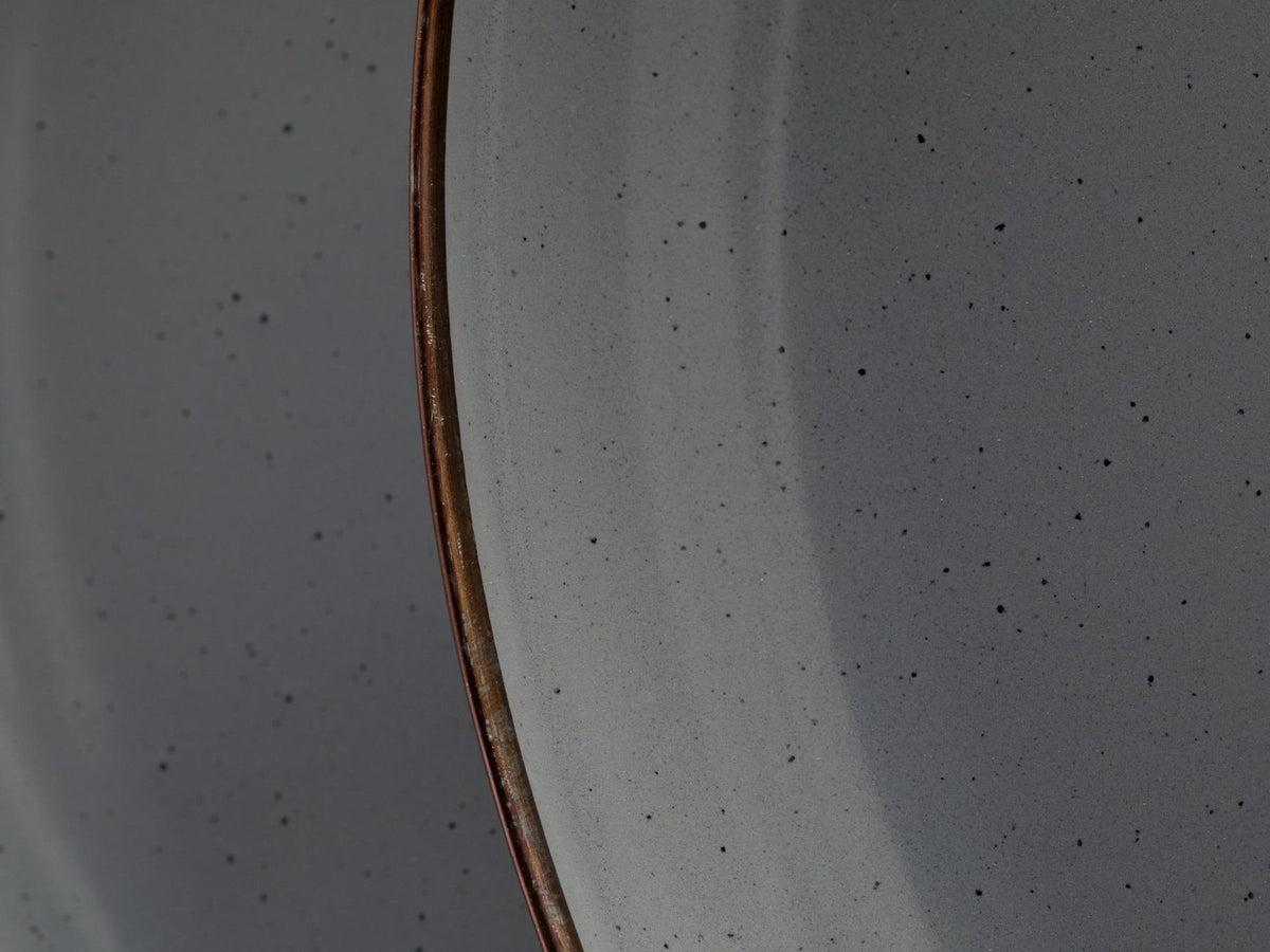 A close up of a Barebones Enamel Mug – Slate Grey (Set of 2) with brown speckles.