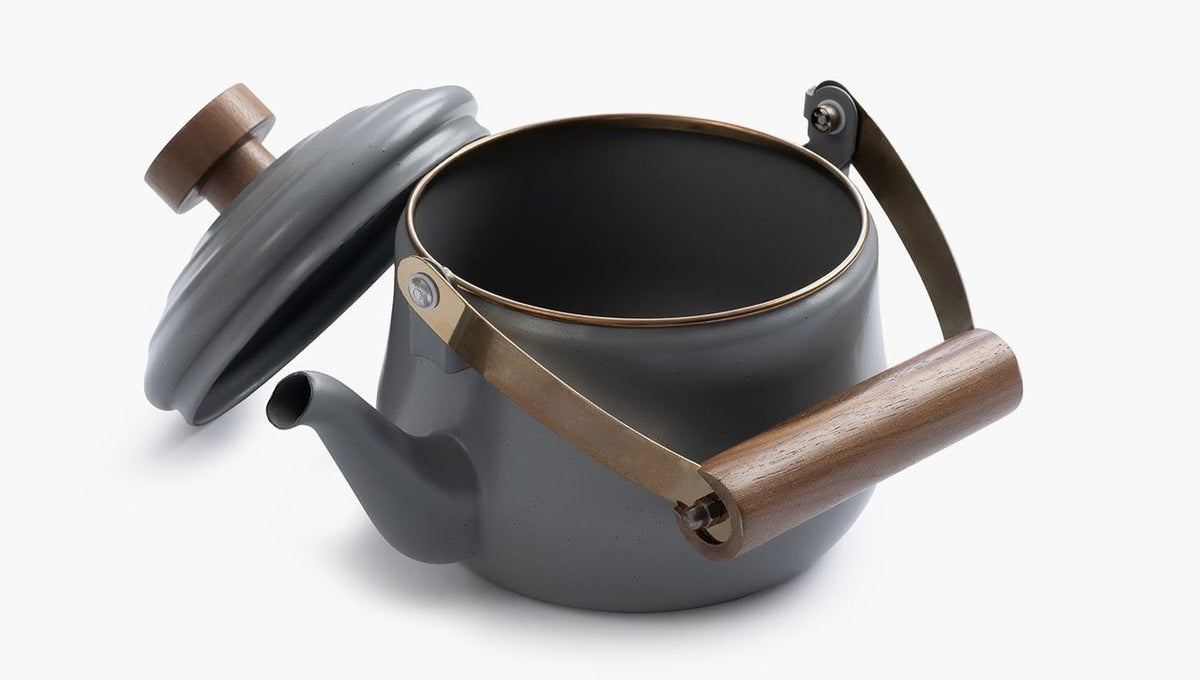 A Barebones Enamel Teapot – Slate Grey with a wooden handle.