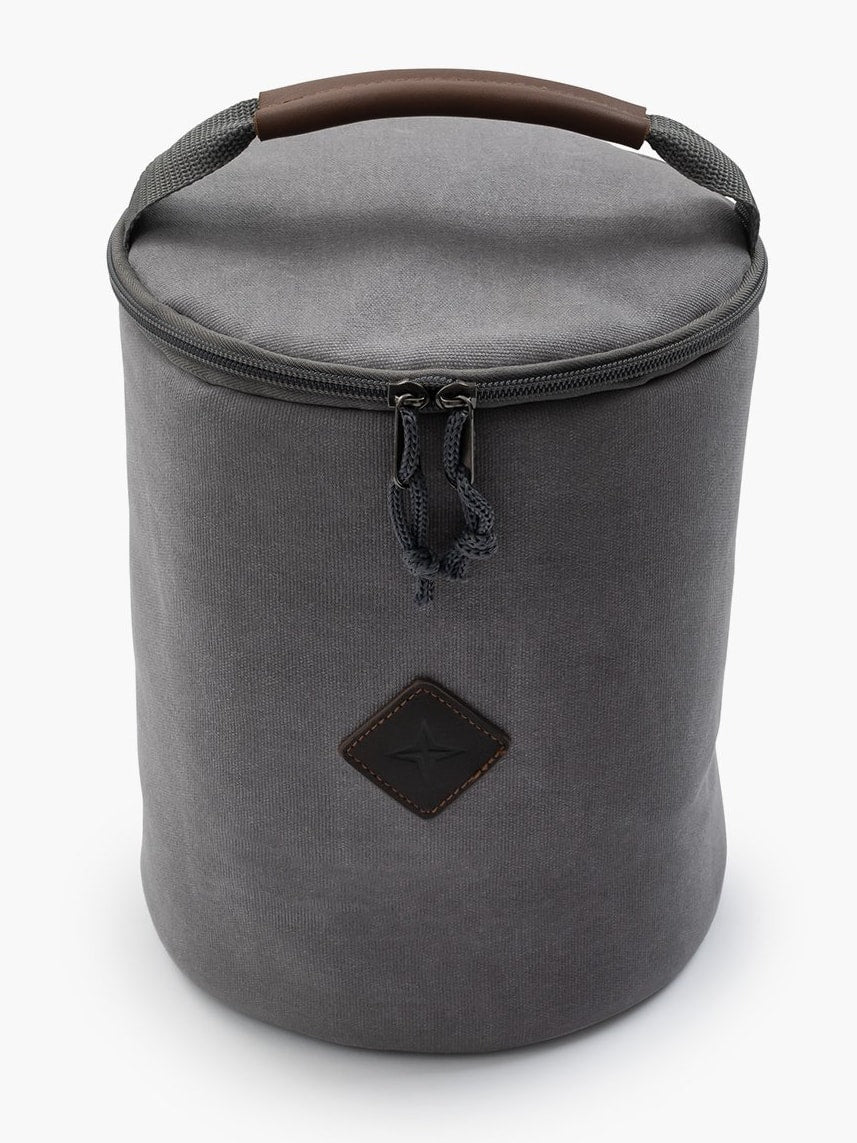 A Lantern Storage Bag – Waxed Canvas by Barebones with a wooden handle.