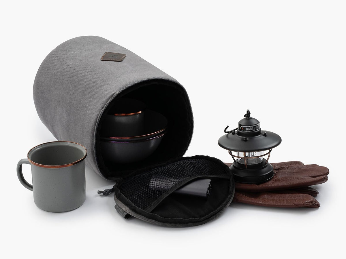 A Barebones Lantern Storage Bag – Waxed Canvas with a mug, gloves and a lantern.