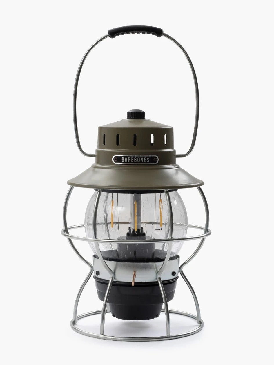 A Barebones Railroad Lantern – Olive Drab with a wire cage on top.