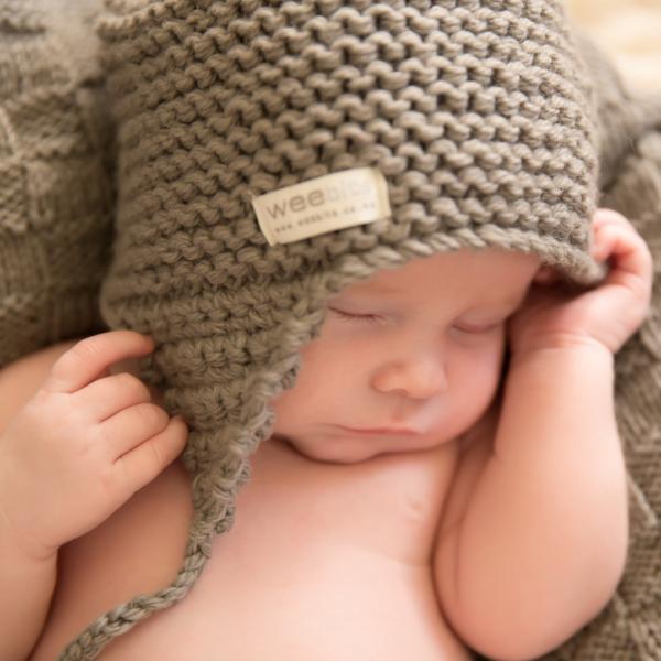 A baby sleeping in a Weebits Hand Knitted Chunky Knit Hat - Mushroom.