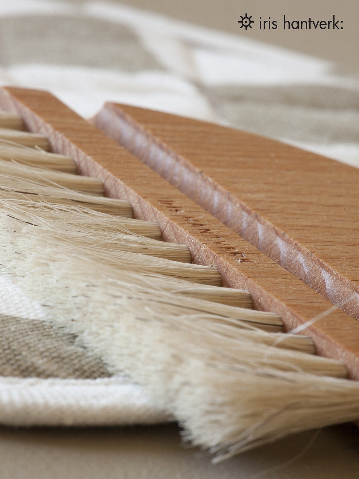A Nesting Table Brush &amp; Pan Set by Iris Hantverk is sitting on top of a piece of cloth.