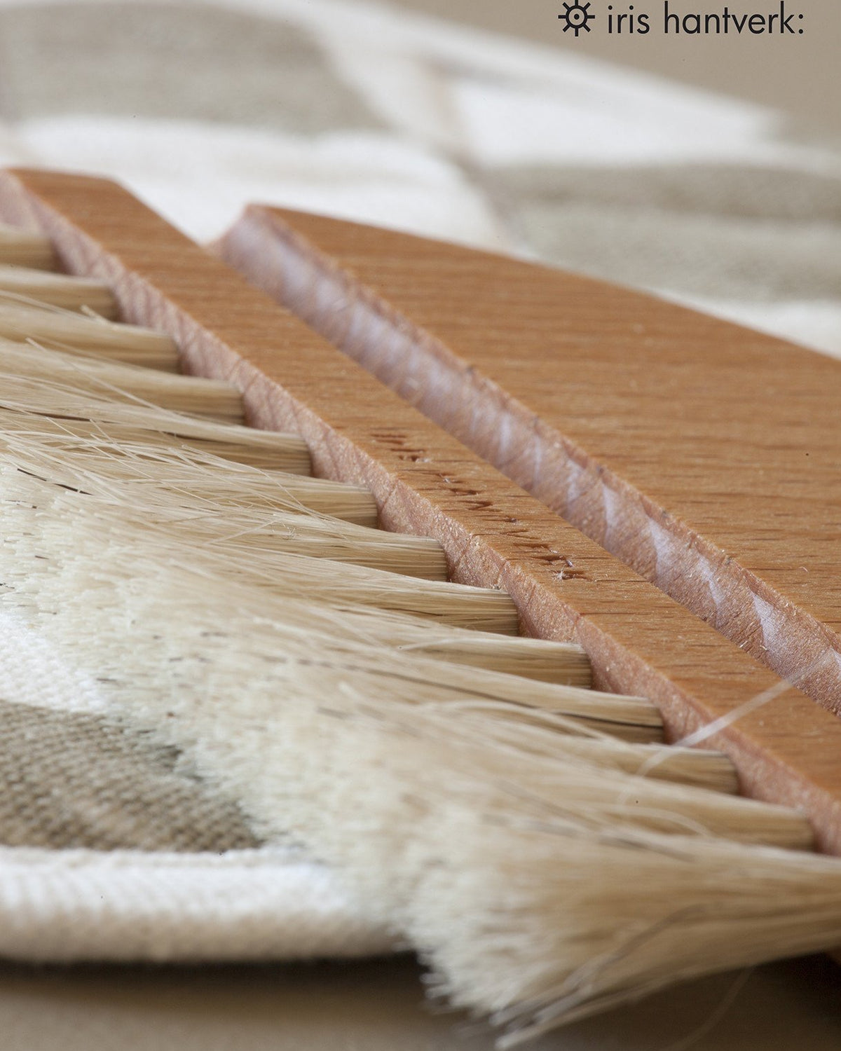 A Nesting Table Brush & Pan Set by Iris Hantverk is sitting on top of a piece of cloth.