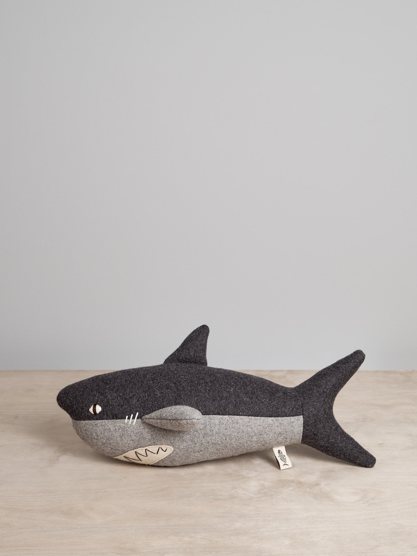 A BEN, the Great White Shark stuffed animal on a wooden table. (Brand: Carapau)