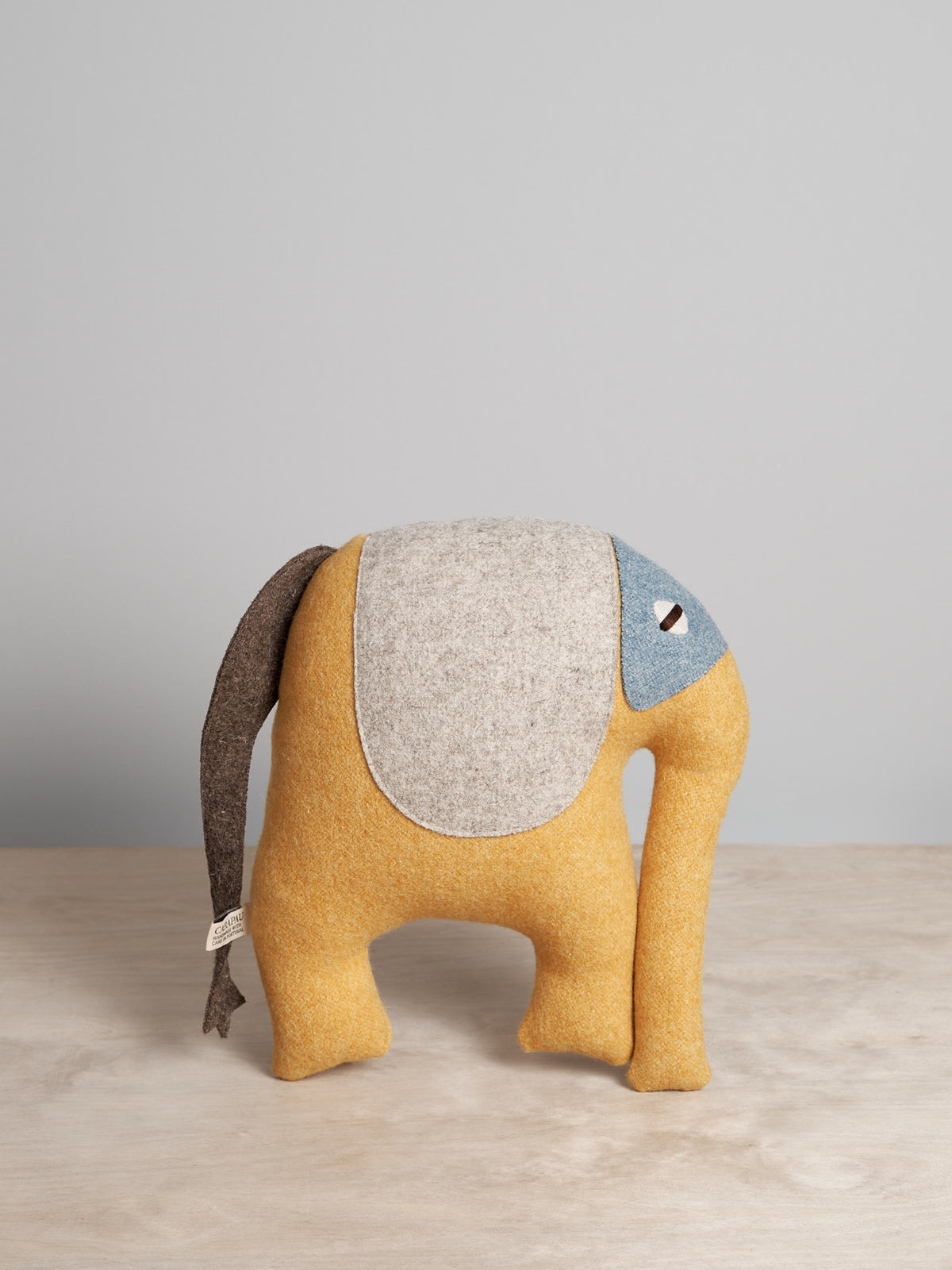 A DEEP, the Indian Elephant stuffed animal on a wooden table