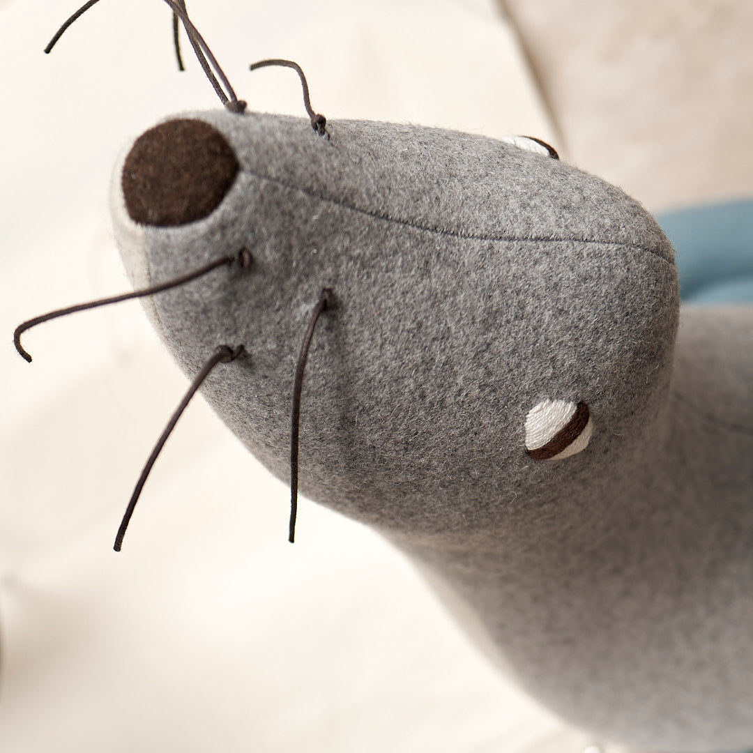 A gray KALI, the Antarctic Fur Seal stuffed animal with a blue collar - from the brand Carapau.
