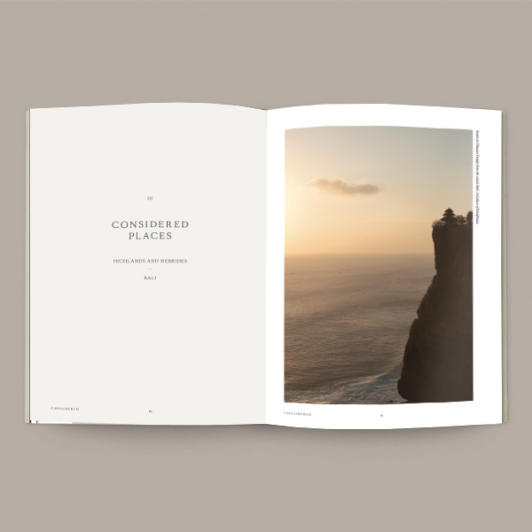An open CONSIDERED Magazine – Vol 2 with an image of a sunset on a cliff.