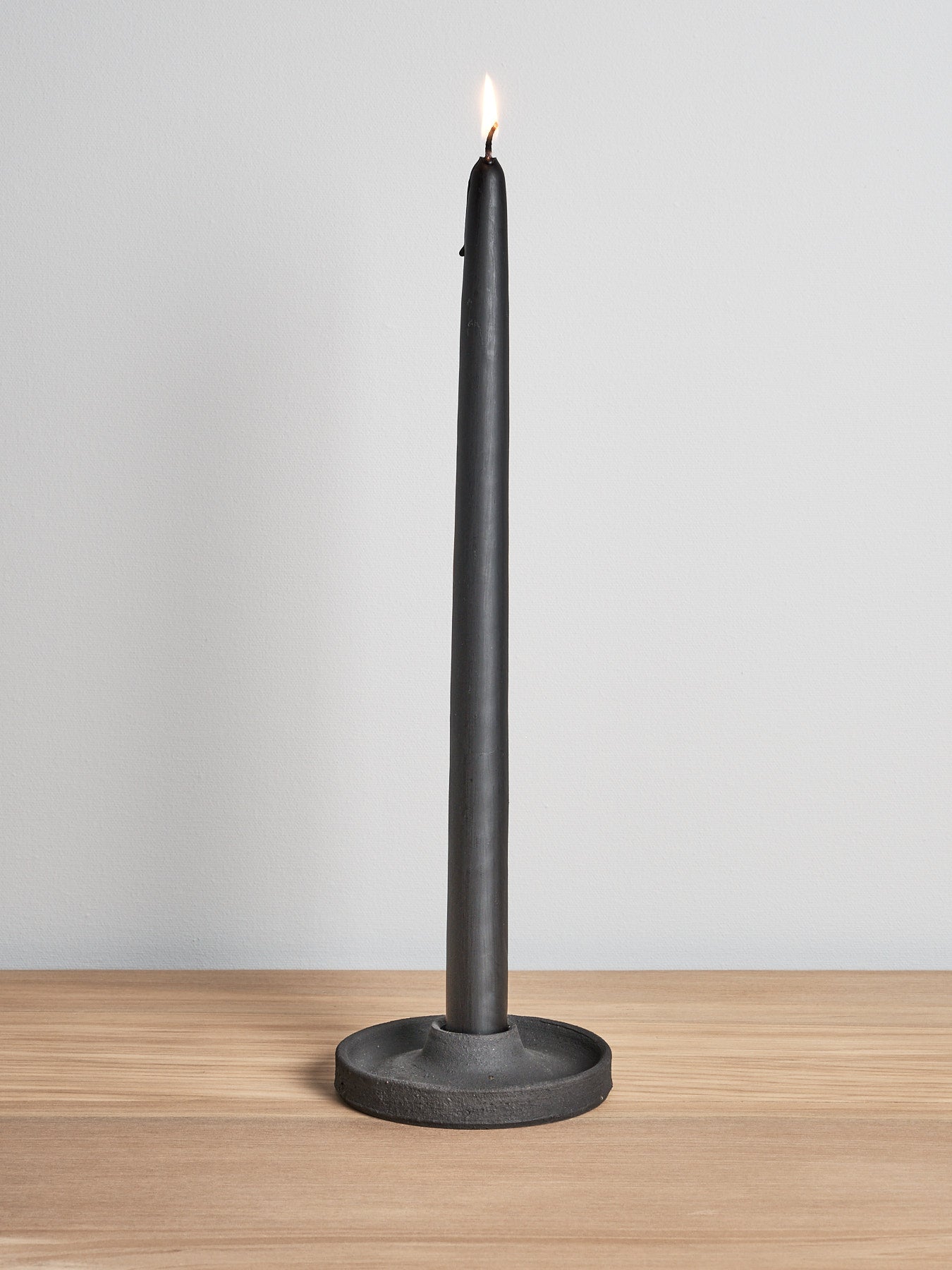 A Candle Holder – Black by deborah sweeney sitting on top of a wooden table.