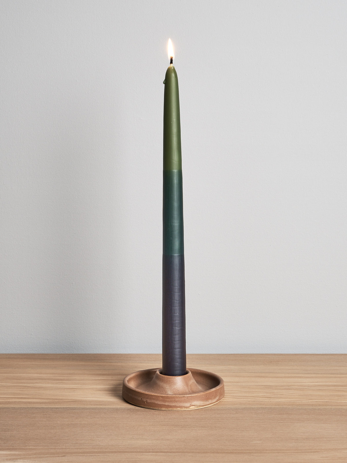 A Candle Holder – Ochre by deborah sweeney sitting on top of a wooden table.