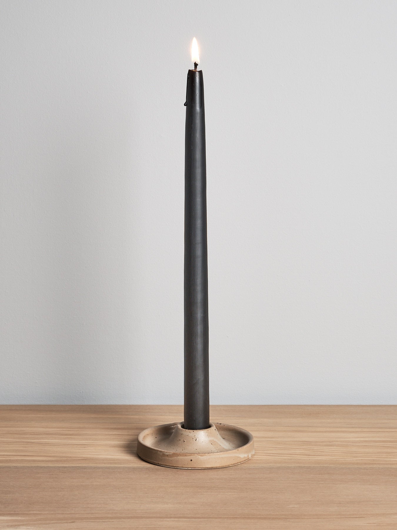 A Candle Holder - Walnut by deborah sweeney is sitting on a wooden table.