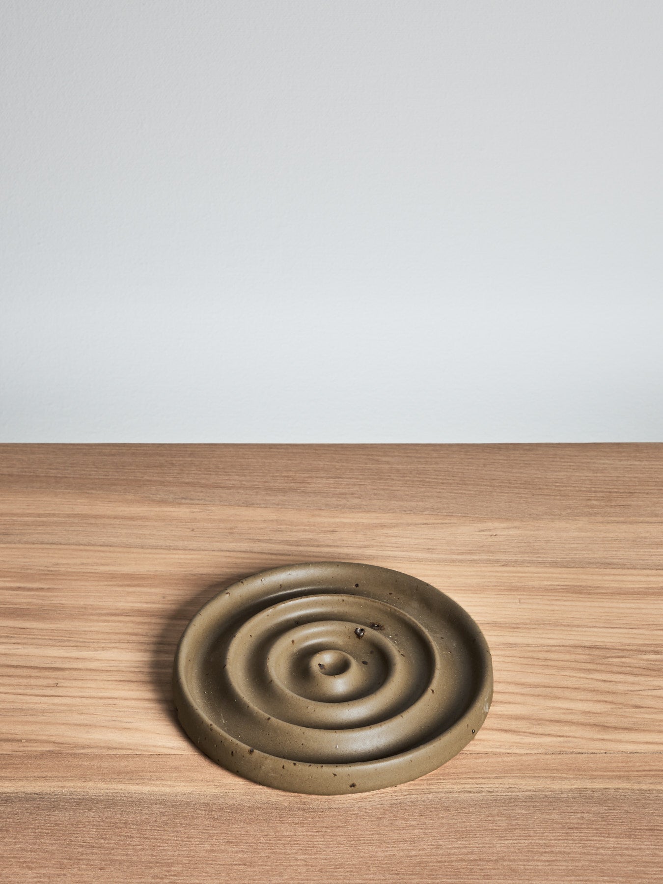 A Soap Dish - Moss by deborah sweeney, placed on a wooden table.