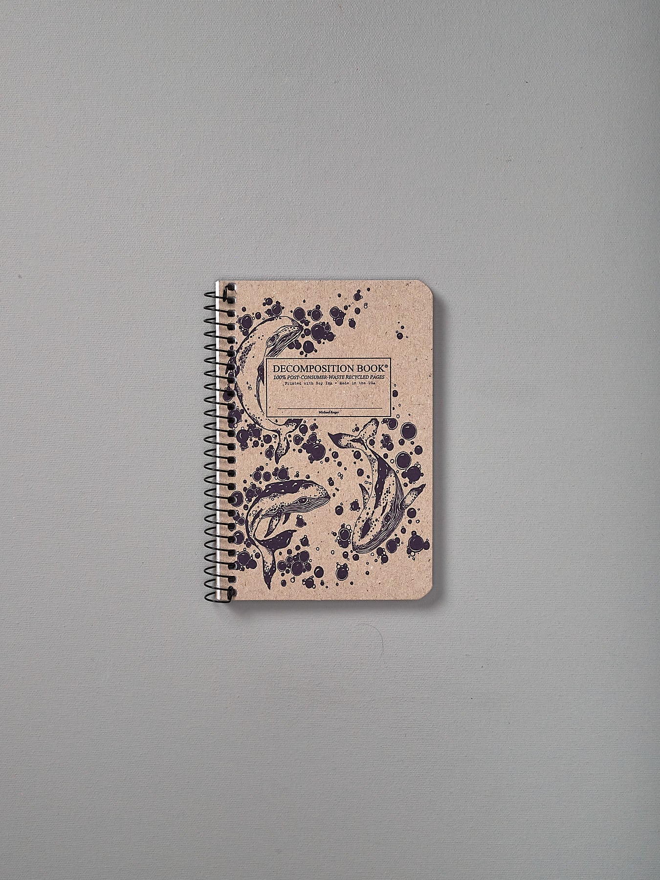 A Decomposition Recycled Notebook - Pocket Sized/Ruled (Humpback Whales) with a pattern on it.