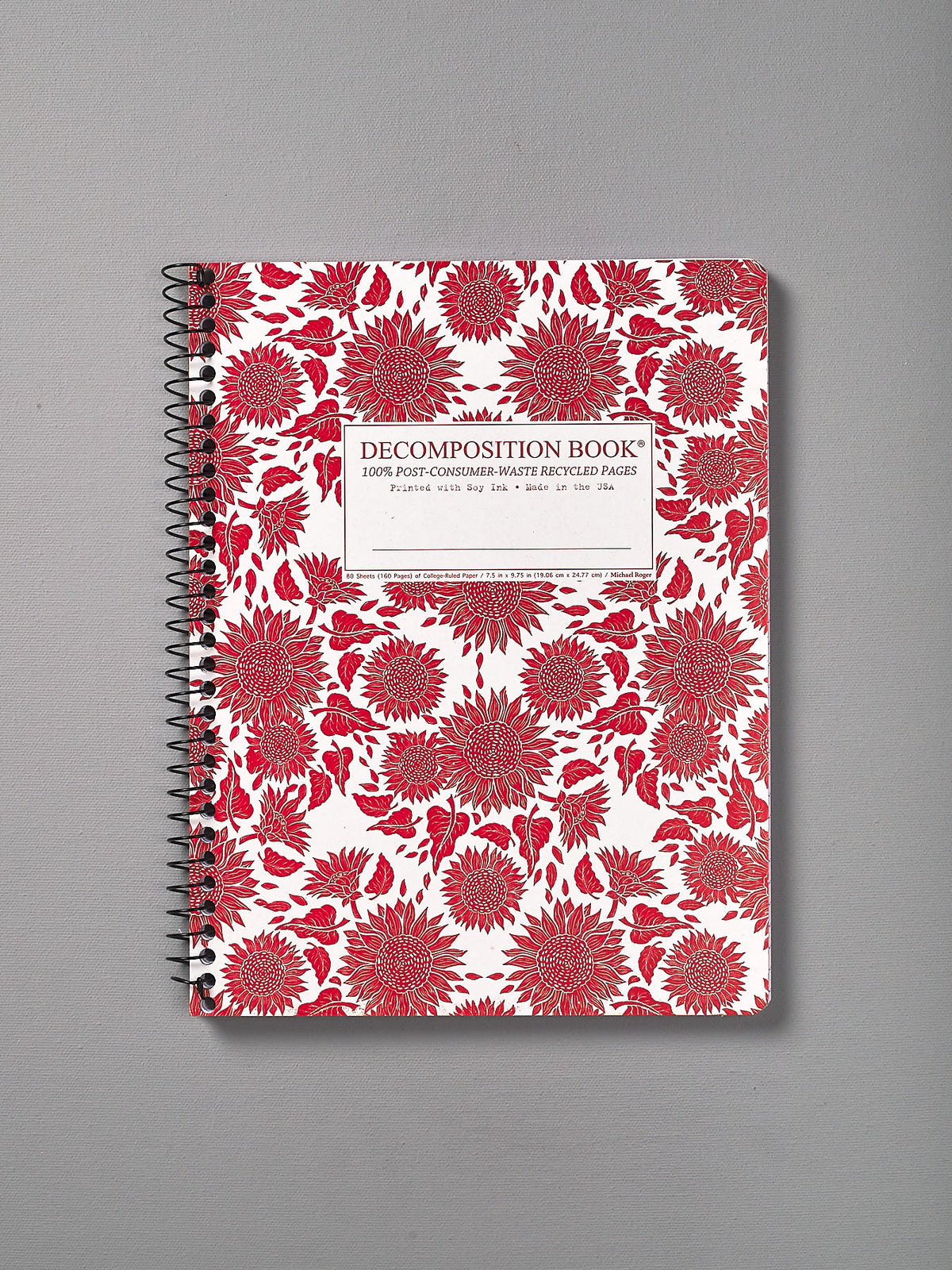 A Decomposition Recycled Notebook – Large/Ruled (Sunflowers) with red and white flowers on it.