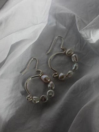A pair of Hypatia Pearl Hoop earrings by EMBR Jewellery.