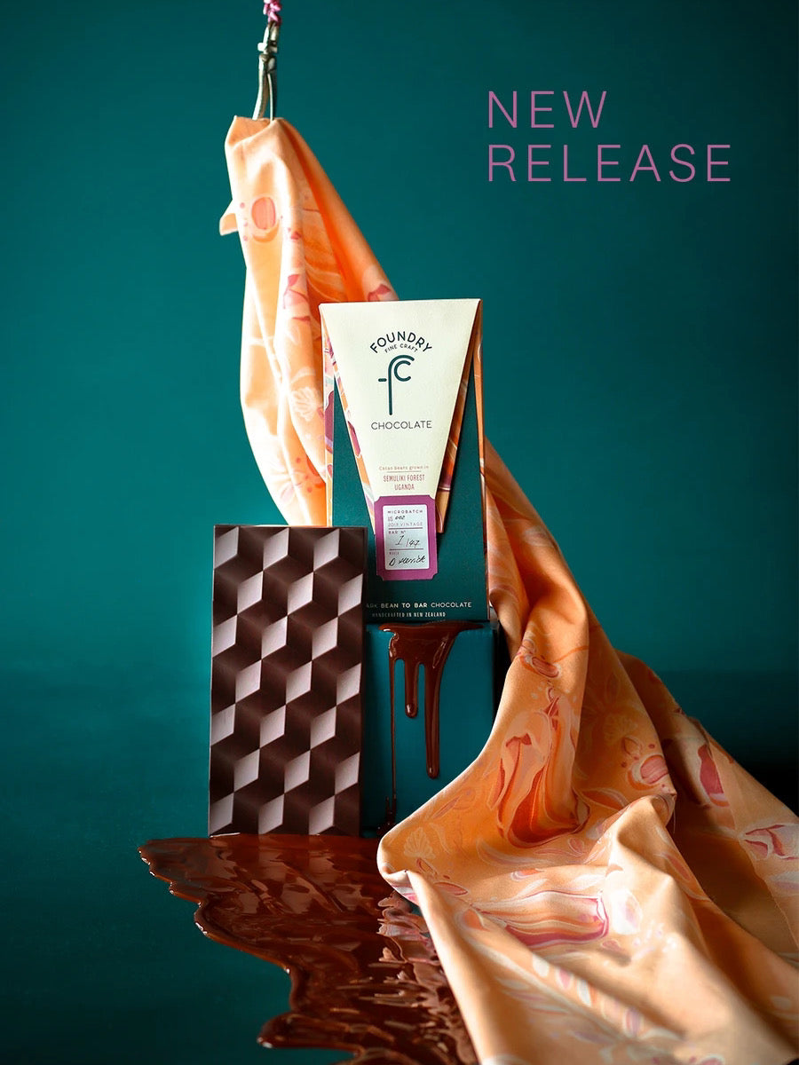 A Foundry Chocolate - Semuliki Forest, Uganda 70% chocolate bar and a scarf with the words new release.
